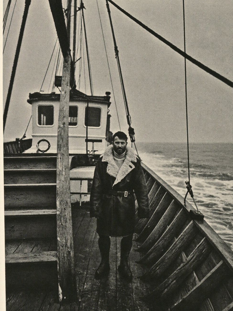Seafarer in a shearling deck coat aboard a fishing vessel in the Barents Sea, archival photograph
