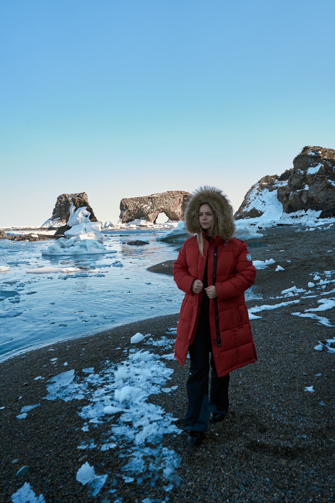 Women's collection — red parka on a winter shore